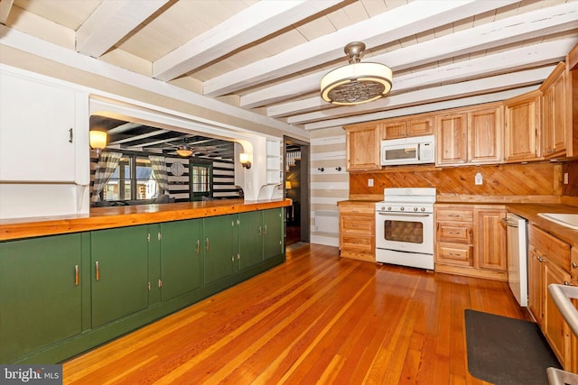 kitchen with wood walls, white appliances, light wood-type flooring, butcher block countertops, and beam ceiling