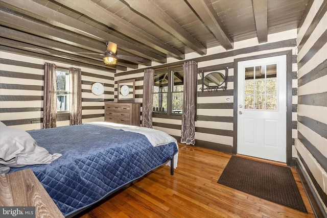 bedroom featuring hardwood / wood-style flooring, beam ceiling, and wooden ceiling