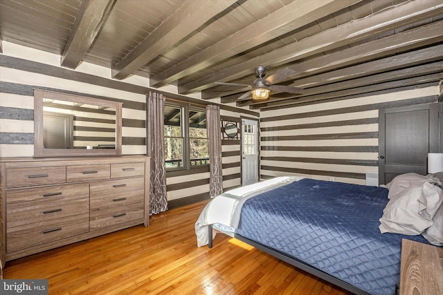 bedroom featuring beamed ceiling, light hardwood / wood-style flooring, and ceiling fan