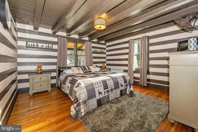 bedroom with hardwood / wood-style flooring, beam ceiling, and wooden ceiling