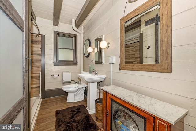 bathroom with beam ceiling, wood-type flooring, and toilet