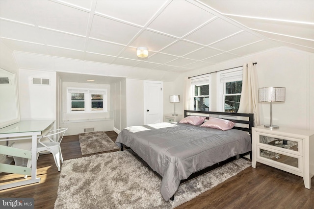 bedroom with dark hardwood / wood-style flooring