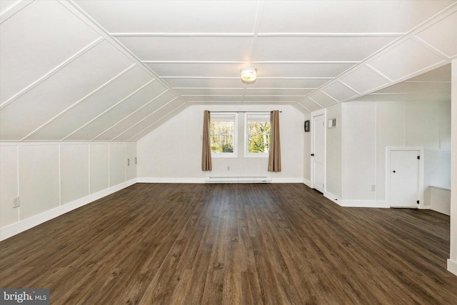 bonus room featuring baseboard heating, vaulted ceiling, and dark hardwood / wood-style floors