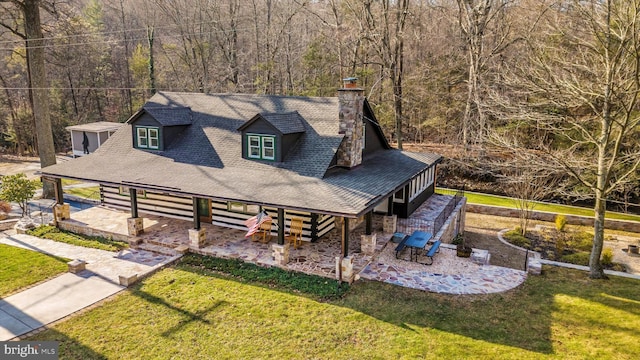 6131 Mountaindale Rd, Thurmont, MD 21788 - view of front of house with a chimney, a shingled roof, a front yard, a patio, and a view of trees