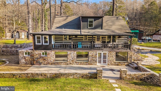 rear view of property with french doors and a patio area