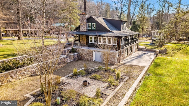 6131 Mountaindale Rd, Thurmont, MD 21788 - back of house featuring stone siding, a yard, dirt driveway, a chimney, and roof with shingles