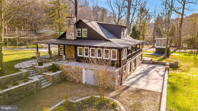 6131 Mountaindale Rd, Thurmont, MD 21788 - view of front of property with a chimney, a patio, roof with shingles, a front yard, and stone siding