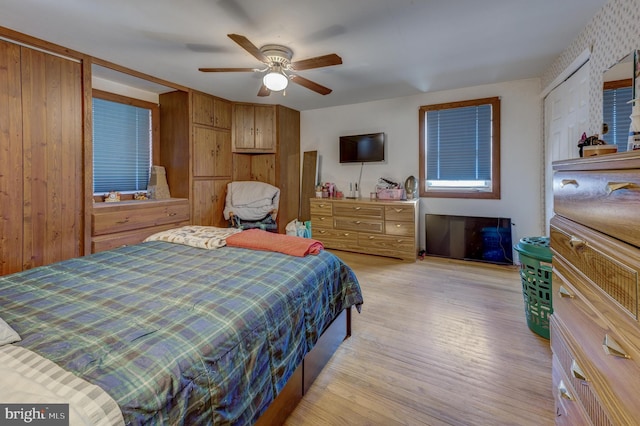 bedroom with ceiling fan and light hardwood / wood-style floors