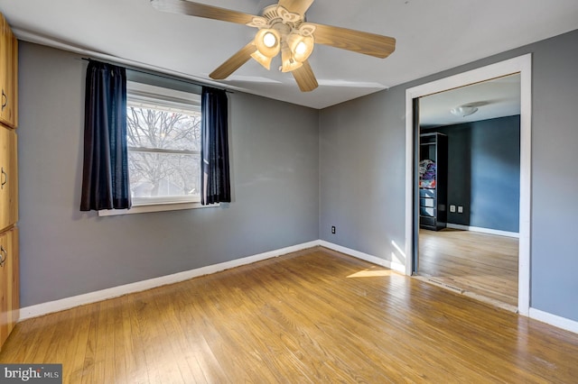 empty room featuring ceiling fan and light hardwood / wood-style floors