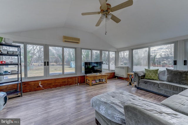 sunroom featuring a wall mounted AC, ceiling fan, and vaulted ceiling