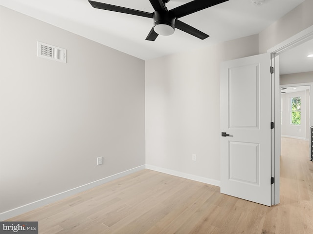 empty room featuring ceiling fan and light hardwood / wood-style floors