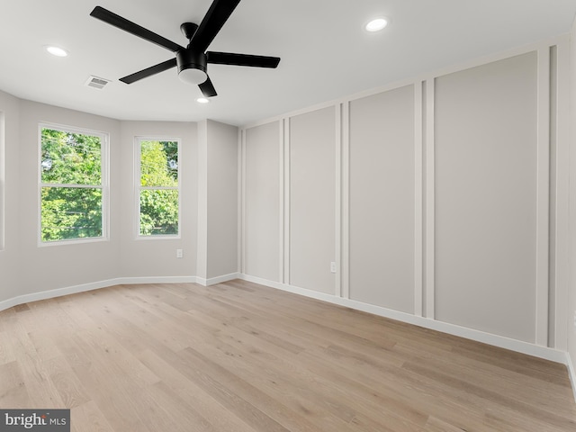 spare room featuring ceiling fan and light hardwood / wood-style flooring