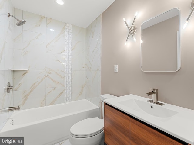 full bathroom with toilet, vanity, and tiled shower / bath