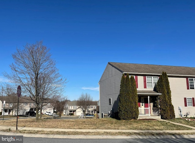 view of side of property featuring a porch