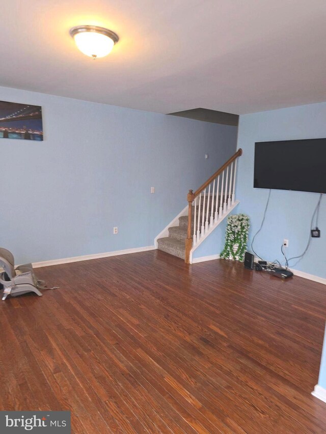 basement with hardwood / wood-style floors