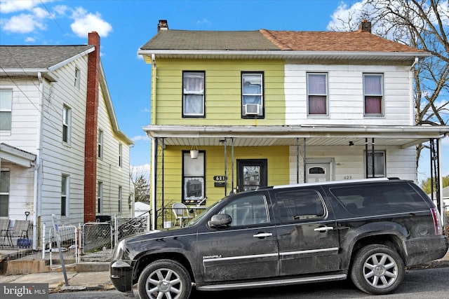 view of front of property featuring covered porch and cooling unit