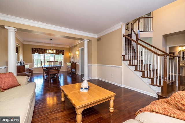 living room featuring crown molding, dark wood-type flooring, and an inviting chandelier