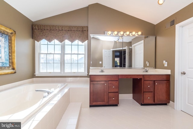 bathroom with vanity, tiled bath, tile patterned floors, and lofted ceiling