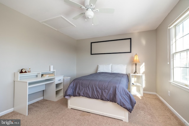 carpeted bedroom featuring multiple windows and ceiling fan