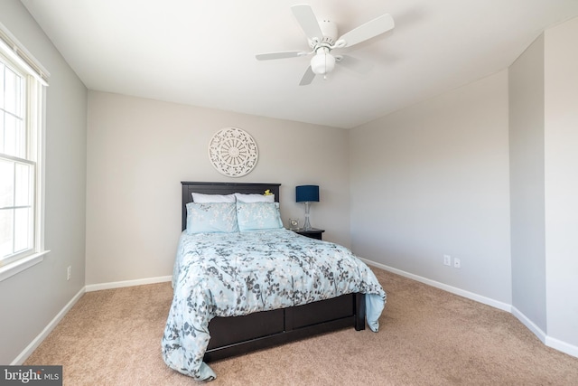 bedroom with carpet flooring, multiple windows, and ceiling fan