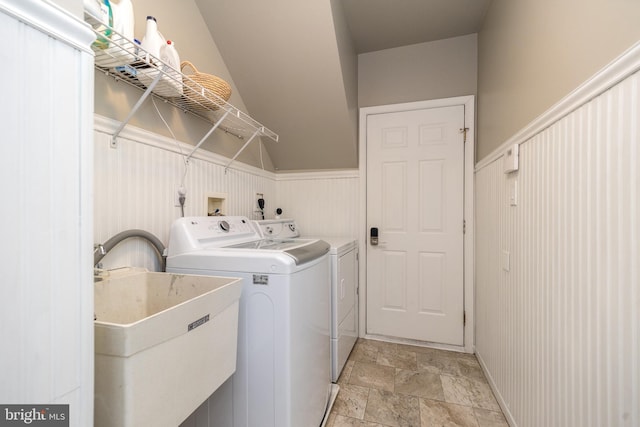 clothes washing area featuring washer and dryer and sink