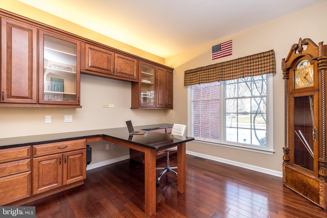 office area with built in desk and dark hardwood / wood-style floors