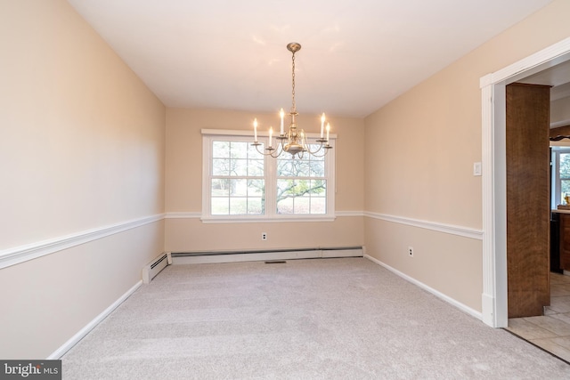 carpeted spare room featuring a baseboard radiator and an inviting chandelier