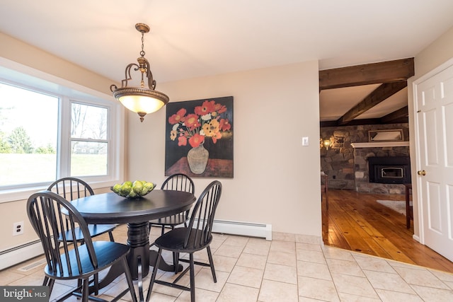 dining area with baseboard heating, light tile patterned flooring, and beam ceiling