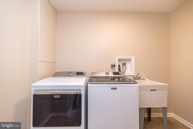 washroom featuring washer and dryer and sink