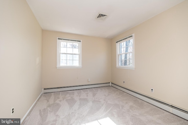 carpeted empty room featuring a healthy amount of sunlight and a baseboard radiator