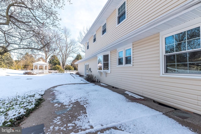 snow covered property with a gazebo