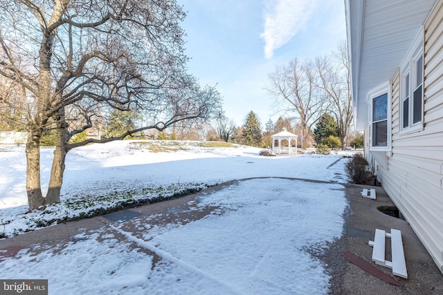 snowy yard featuring a gazebo