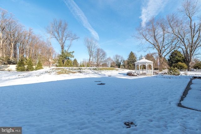 snowy yard featuring a gazebo