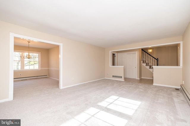 unfurnished living room with an inviting chandelier, light colored carpet, and a baseboard heating unit