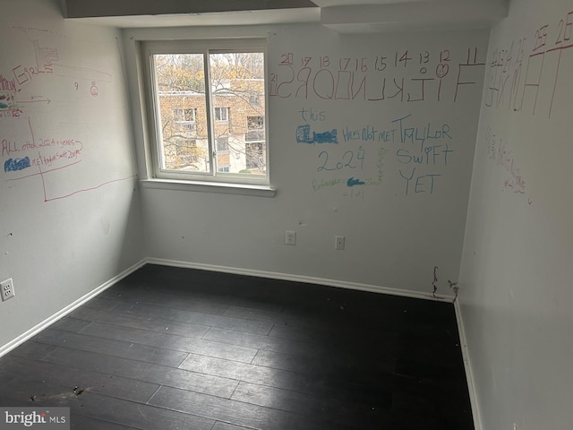 spare room featuring dark hardwood / wood-style floors