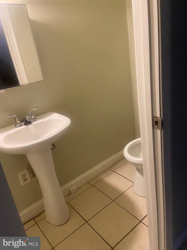 bathroom featuring tile patterned floors, sink, and toilet