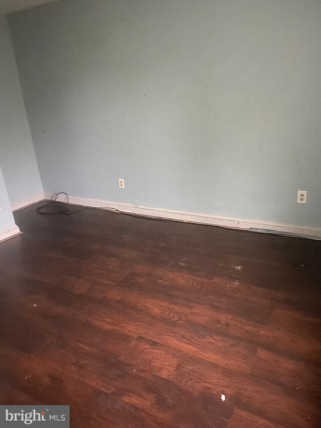 empty room with dark wood-type flooring