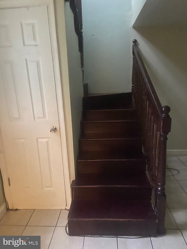 staircase featuring tile patterned floors