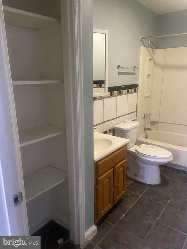 full bathroom with backsplash, tub / shower combination, vanity, tile patterned flooring, and toilet