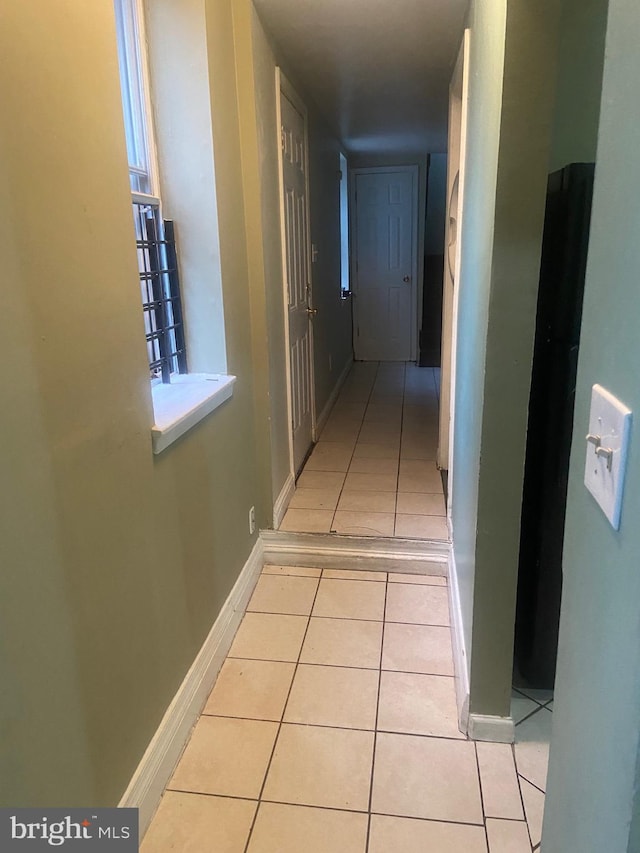 hall with light tile patterned flooring