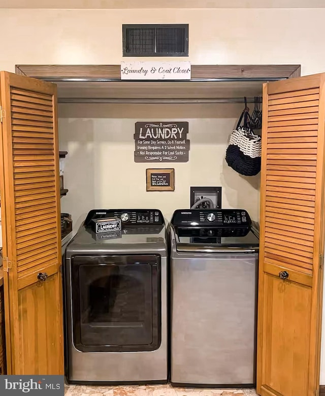 clothes washing area featuring washer and dryer