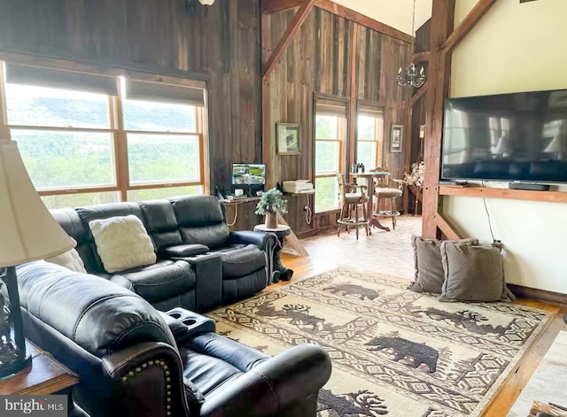 living room with plenty of natural light, wood walls, and wood-type flooring