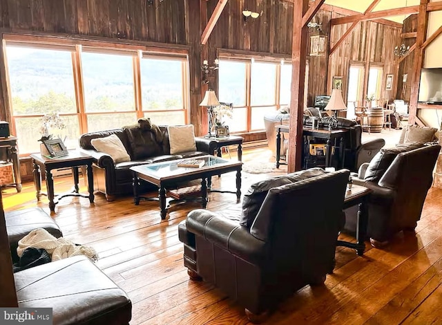 living room featuring hardwood / wood-style flooring and wood walls