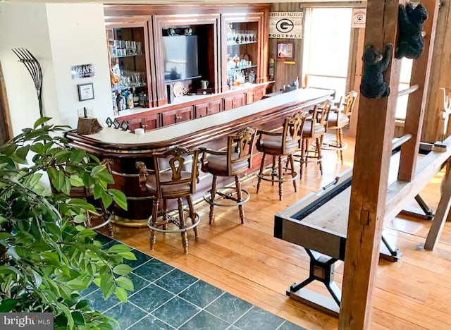 bar with hardwood / wood-style flooring