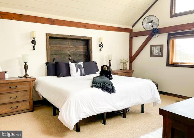 bedroom featuring light colored carpet and vaulted ceiling