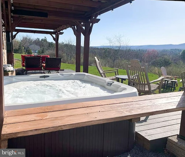 wooden terrace with a hot tub