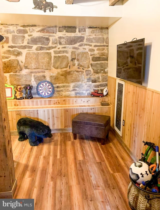 room details featuring hardwood / wood-style flooring and wooden walls