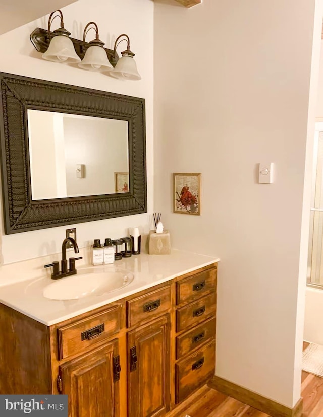 bathroom with vanity and hardwood / wood-style flooring