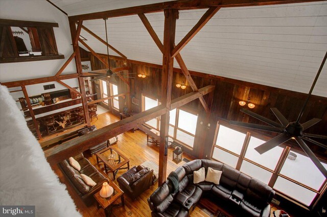 living room featuring ceiling fan, lofted ceiling, and hardwood / wood-style flooring