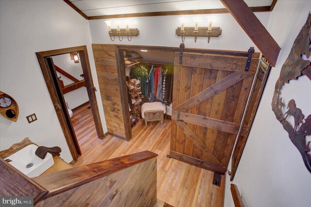 interior space with a barn door and wood-type flooring